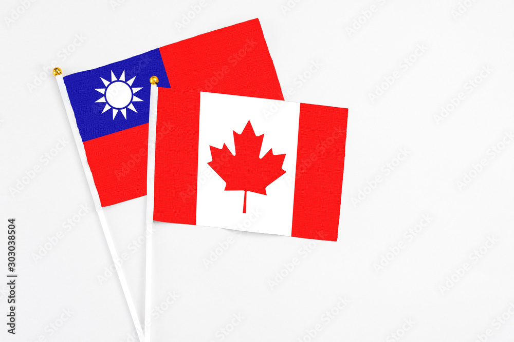 Canada and Taiwan stick flags on white background. High quality fabric, miniature national flag. Peaceful global concept.White floor for copy space. Canada and Taiwan stick flags on white background. High quality fabric, miniature national flag. Peaceful global concept.White floor for copy space.