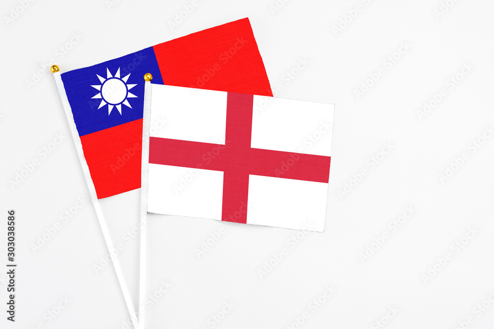 England and Taiwan stick flags on white background. High quality fabric, miniature national flag. Peaceful global concept.White floor for copy space.