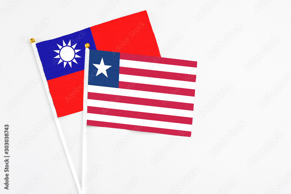 Liberia and Taiwan stick flags on white background. High quality fabric, miniature national flag. Peaceful global concept.White floor for copy space. Liberia and Taiwan stick flags on white background. High quality fabric, miniature national flag. Peaceful global concept.White floor for copy space.