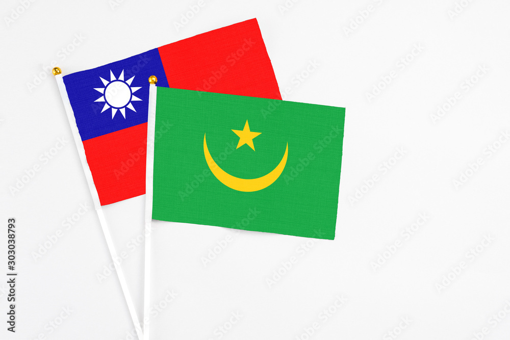 Mauritania and Taiwan stick flags on white background. High quality fabric, miniature national flag. Peaceful global concept.White floor for copy space. Mauritania and Taiwan stick flags on white background. High quality fabric, miniature national flag. Peaceful global concept.White floor for copy space.