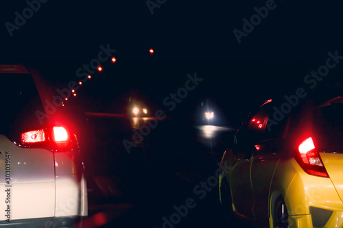Blurred of two car on night road prepare for race or stop by traffic light control. Dark night time.