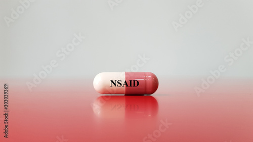 Capsule of NSAID drug on white background(Nonsteroidal anti-inflammatory drug). This medication used for pain control, decrease inflammation, fever treatment, prevent blood clot. Medical concept photo