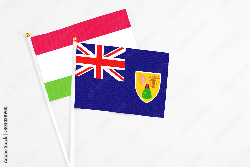 Turks And Caicos Islands and Tajikistan stick flags on white background. High quality fabric, miniature national flag. Peaceful global concept.White floor for copy space. Turks And Caicos Islands and Tajikistan stick flags on white background. High quality fabric, miniature national flag. Peaceful global concept.White floor for copy space.