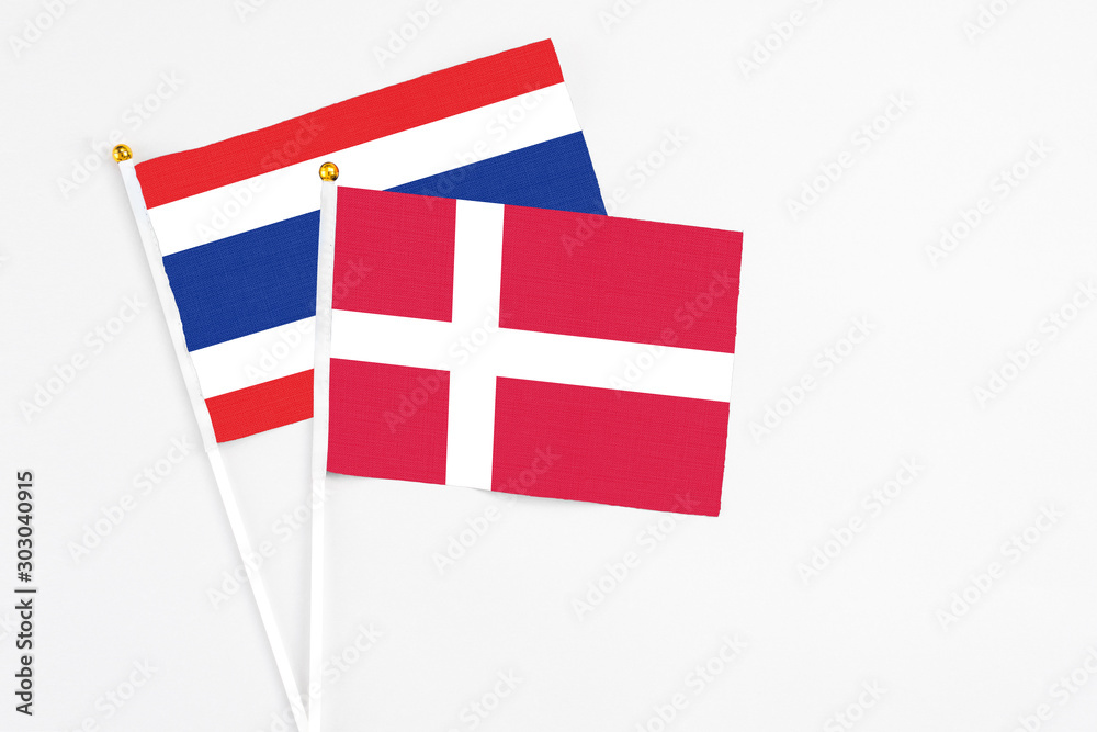 Denmark and Thailand stick flags on white background. High quality fabric, miniature national flag. Peaceful global concept.White floor for copy space.