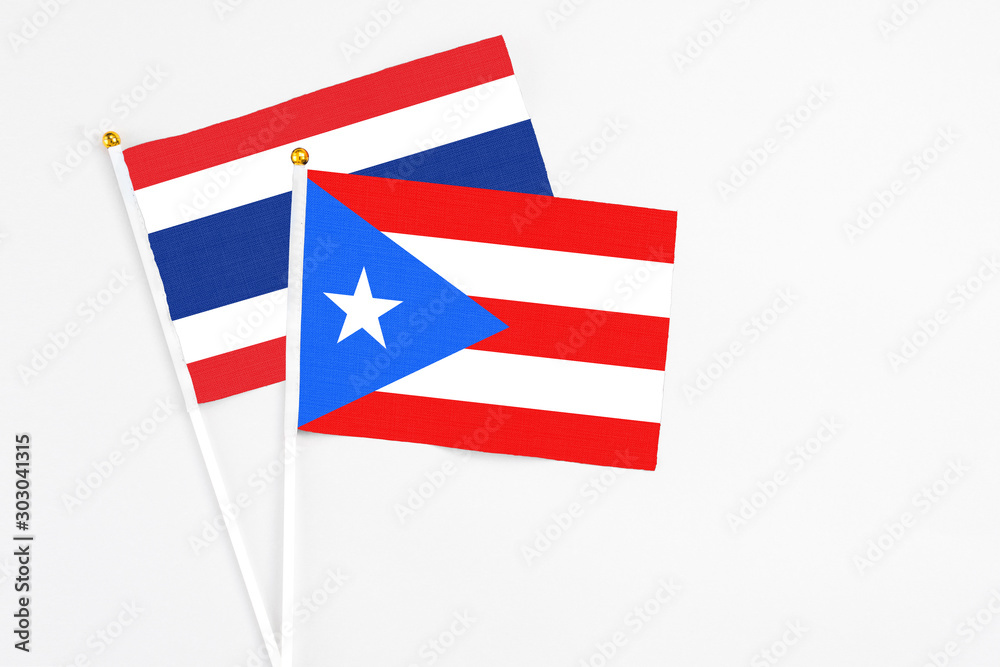 Puerto Rico and Thailand stick flags on white background. High quality fabric, miniature national flag. Peaceful global concept.White floor for copy space. Puerto Rico and Thailand stick flags on white background. High quality fabric, miniature national flag. Peaceful global concept.White floor for copy space.