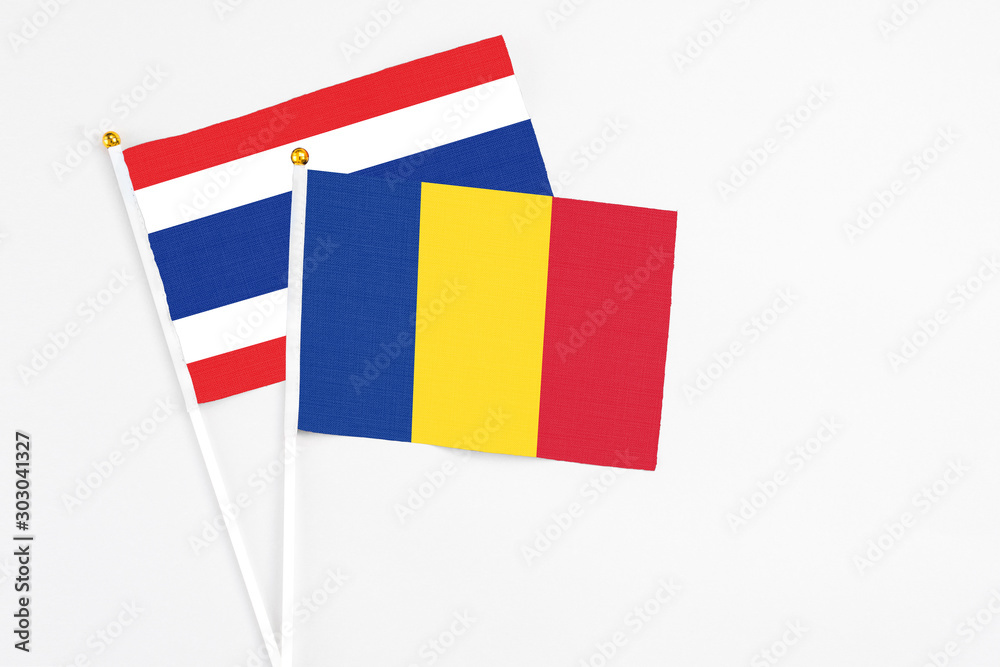 Romania and Thailand stick flags on white background. High quality fabric, miniature national flag. Peaceful global concept.White floor for copy space. Romania and Thailand stick flags on white background. High quality fabric, miniature national flag. Peaceful global concept.White floor for copy space.