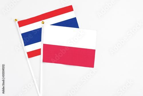 Free Download Poland and Thailand stick flags on white background. High quality fabric, miniature national flag. Peaceful global concept.White floor for copy space. - GFXLoad