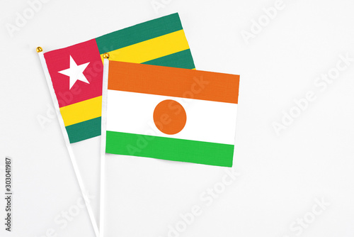 Free Download Niger and Togo stick flags on white background. High quality fabric, miniature national flag. Peaceful global concept.White floor for copy space. - GFXLoad