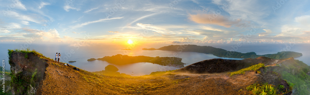Sunrise panorama from Gunung Api volcano, overlooking Banda Neira island, Maluku. Banda is the famous hub of Indonesia's Spice Islands, once traded for Manhattan for access to lucrative nutmeg crops