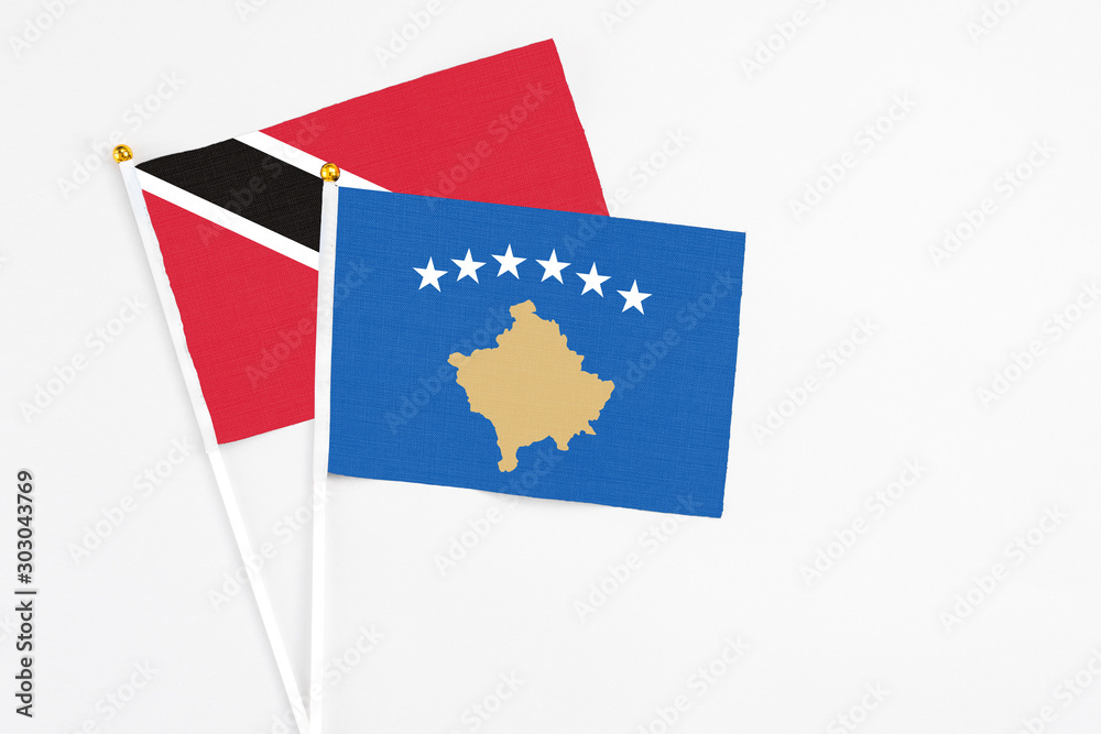 Kosovo and Trinidad And Tobago stick flags on white background. High quality fabric, miniature national flag. Peaceful global concept.White floor for copy space. Kosovo and Trinidad And Tobago stick flags on white background. High quality fabric, miniature national flag. Peaceful global concept.White floor for copy space.