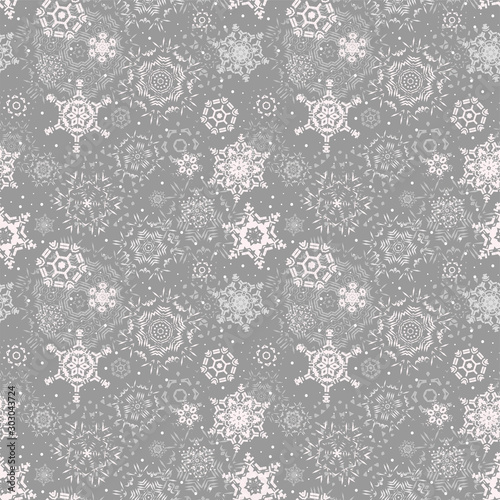 Christmas seamless pattern with snowflakes on a light gray background. Falling snow backdrop. Winter ornament. Christmas print, Wallpaper, pattern for textiles, wrapping paper. Vector.