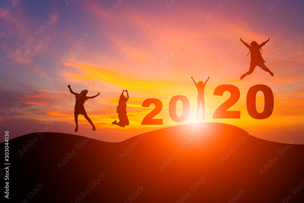 Silhouette jumping people on mountain with twilight sky in sunrise or sunset celebrate new year 2020