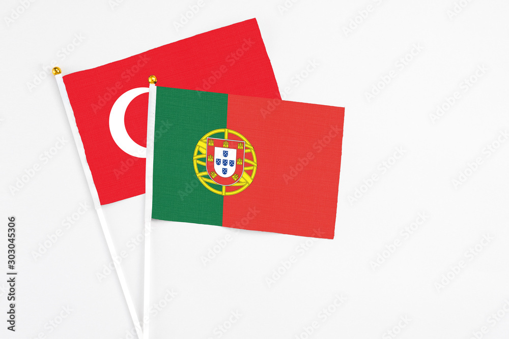 Portugal and Turkey stick flags on white background. High quality fabric, miniature national flag. Peaceful global concept.White floor for copy space. Portugal and Turkey stick flags on white background. High quality fabric, miniature national flag. Peaceful global concept.White floor for copy space.