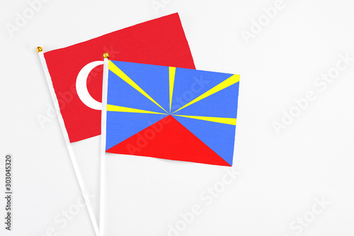 Reunion and Turkey stick flags on white background. High quality fabric, miniature national flag. Peaceful global concept.White floor for copy space.