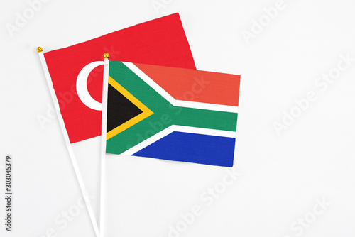 South Africa and Turkey stick flags on white background. High quality fabric  miniature national flag. Peaceful global concept.White floor for copy space.