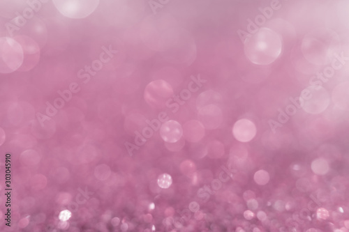 Pink pastel sparkle glitter from diamond dust falling on the floor. Have a lot of bokeh in very soft blur light