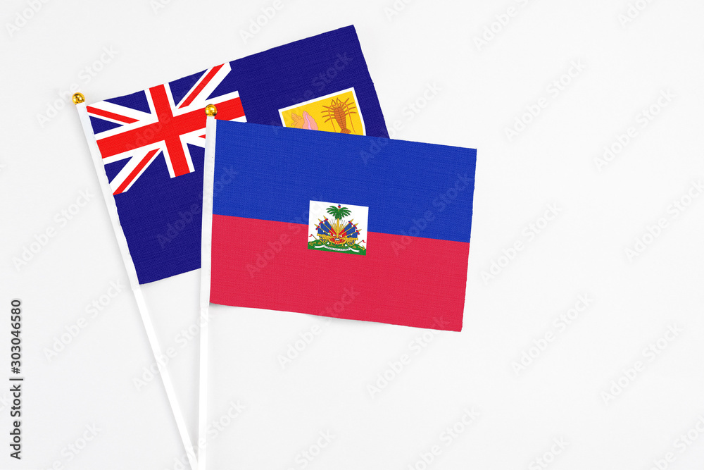 Haiti and Turks And Caicos Islands stick flags on white background. High quality fabric, miniature national flag. Peaceful global concept.White floor for copy space.