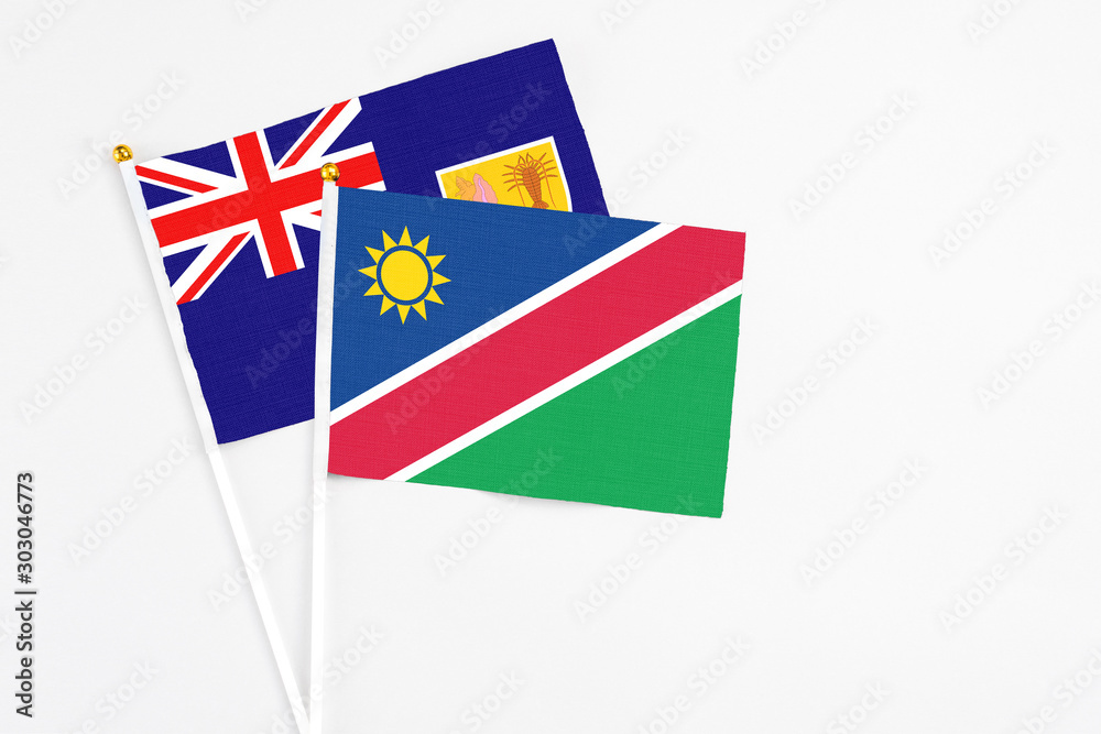 Namibia and Turks And Caicos Islands stick flags on white background. High quality fabric, miniature national flag. Peaceful global concept.White floor for copy space. Namibia and Turks And Caicos Islands stick flags on white background. High quality fabric, miniature national flag. Peaceful global concept.White floor for copy space.