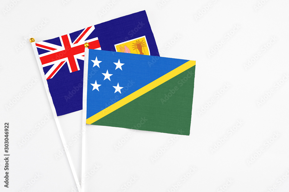 Solomon Islands and Turks And Caicos Islands stick flags on white background. High quality fabric, miniature national flag. Peaceful global concept.White floor for copy space. Solomon Islands and Turks And Caicos Islands stick flags on white background. High quality fabric, miniature national flag. Peaceful global concept.White floor for copy space.