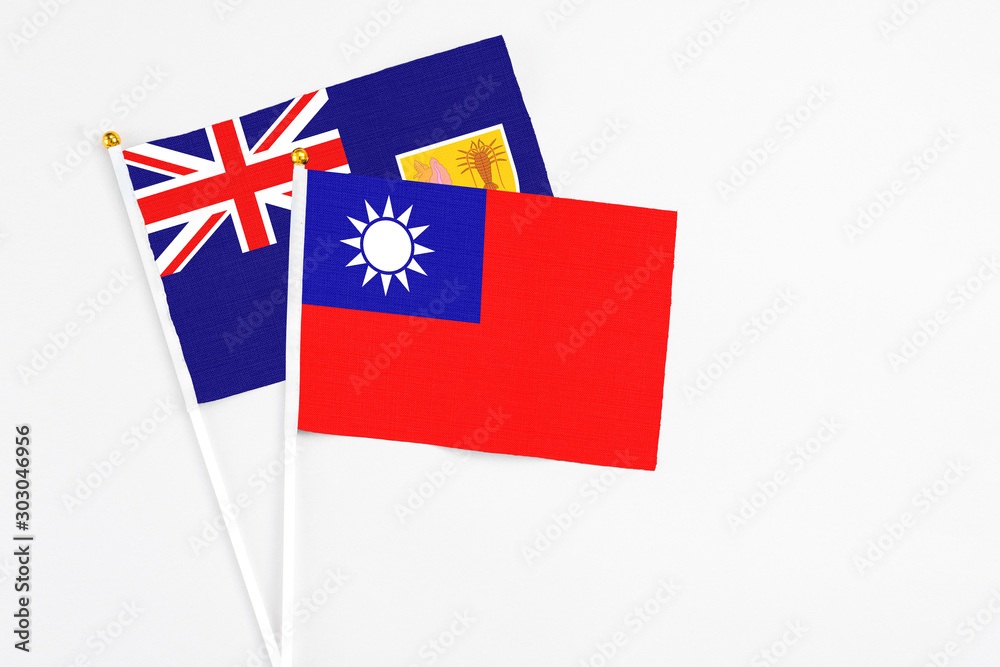 Taiwan and Turks And Caicos Islands stick flags on white background. High quality fabric, miniature national flag. Peaceful global concept.White floor for copy space.