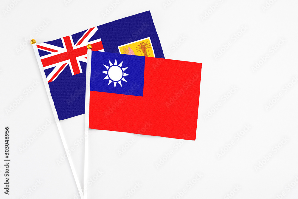 Fototapeta premium Taiwan and Turks And Caicos Islands stick flags on white background. High quality fabric, miniature national flag. Peaceful global concept.White floor for copy space.