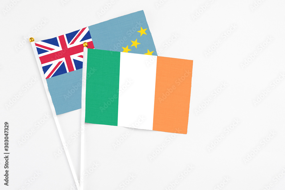 Ireland and Tuvalu stick flags on white background. High quality fabric, miniature national flag. Peaceful global concept.White floor for copy space. Ireland and Tuvalu stick flags on white background. High quality fabric, miniature national flag. Peaceful global concept.White floor for copy space.