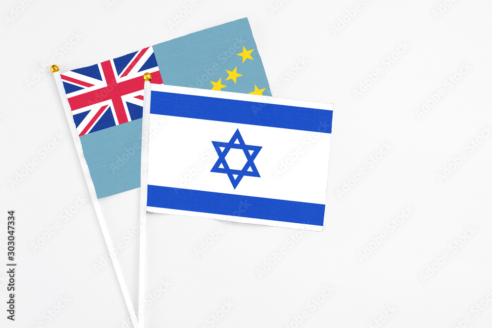 Fototapeta premium Israel and Tuvalu stick flags on white background. High quality fabric, miniature national flag. Peaceful global concept.White floor for copy space.