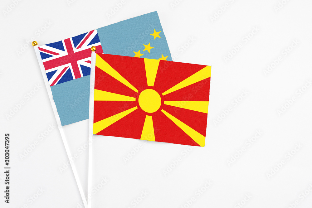 Macedonia and Tuvalu stick flags on white background. High quality fabric, miniature national flag. Peaceful global concept.White floor for copy space.