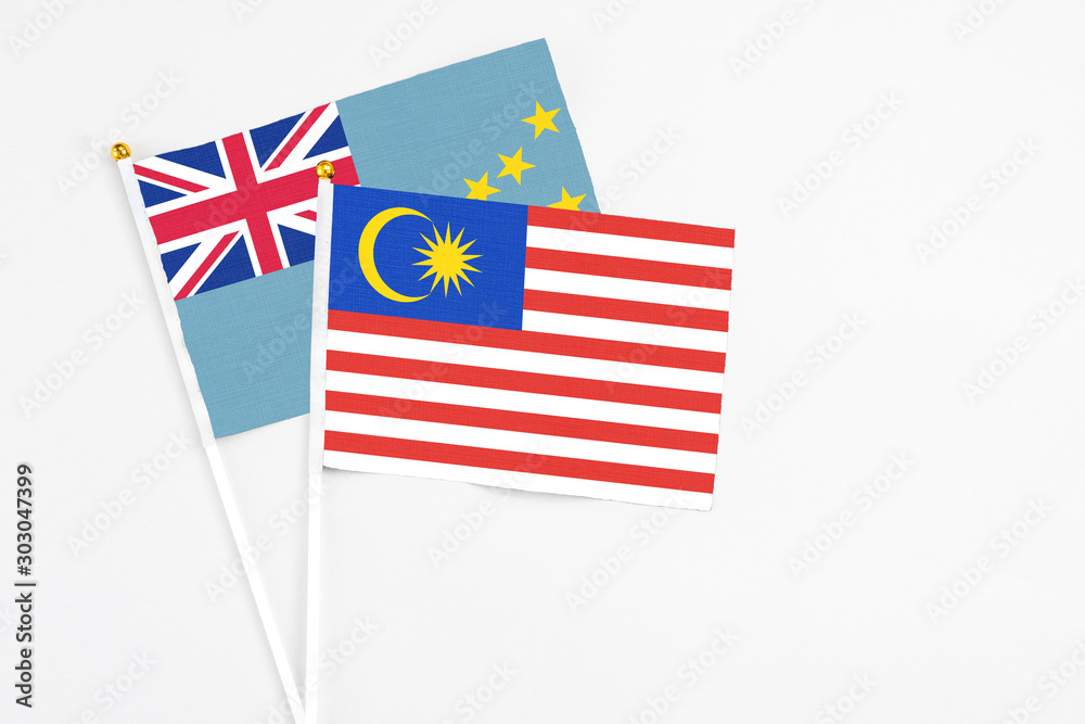 Malaysia and Tuvalu stick flags on white background. High quality fabric, miniature national flag. Peaceful global concept.White floor for copy space. Malaysia and Tuvalu stick flags on white background. High quality fabric, miniature national flag. Peaceful global concept.White floor for copy space.