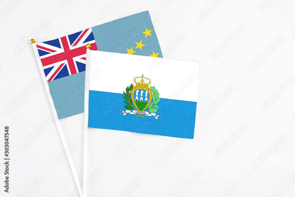 San Marino and Tuvalu stick flags on white background. High quality fabric, miniature national flag. Peaceful global concept.White floor for copy space. San Marino and Tuvalu stick flags on white background. High quality fabric, miniature national flag. Peaceful global concept.White floor for copy space.