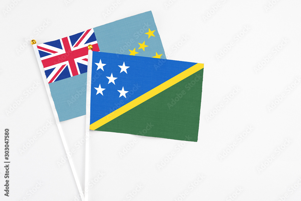 Solomon Islands and Tuvalu stick flags on white background. High quality fabric, miniature national flag. Peaceful global concept.White floor for copy space. Solomon Islands and Tuvalu stick flags on white background. High quality fabric, miniature national flag. Peaceful global concept.White floor for copy space.