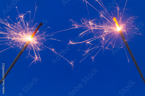 Two burning sparklers close up
