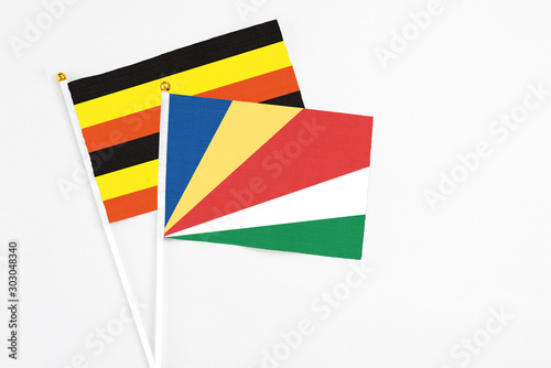 Free Download Seychelles and Uganda stick flags on white background. High quality fabric, miniature national flag. Peaceful global concept.White floor for copy space. - GFXLoad