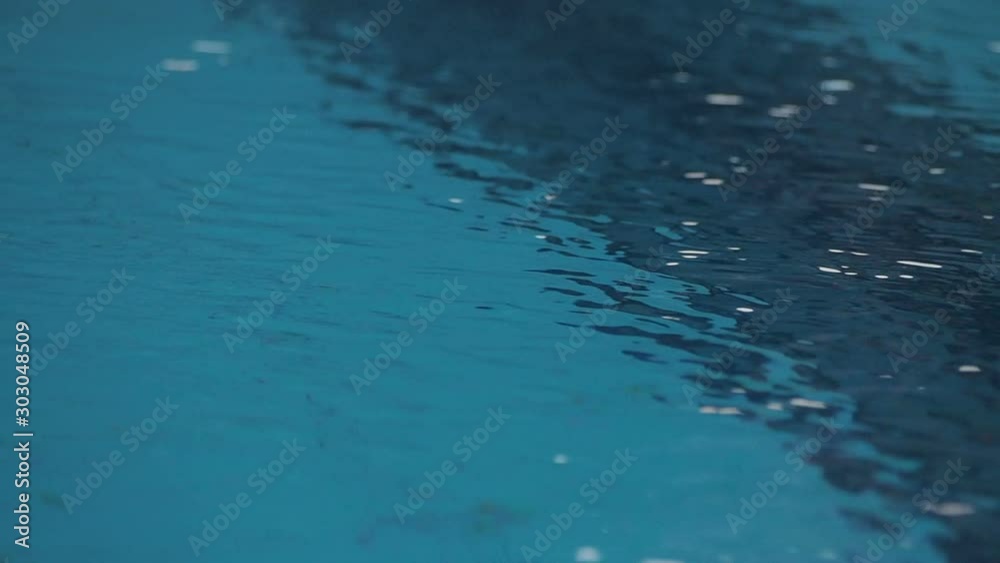 Ripples on the water surface of swimming pool close-up Ripples on the water surface of swimming pool close-up