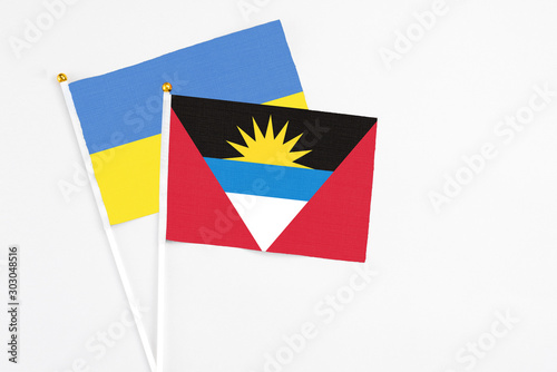 Free Download Antigua and Barbuda and Ukraine stick flags on white background. High quality fabric, miniature national flag. Peaceful global concept.White floor for copy space. - GFXLoad