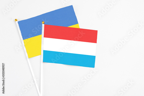 Free Download Luxembourg and Ukraine stick flags on white background. High quality fabric, miniature national flag. Peaceful global concept.White floor for copy space. - GFXLoad