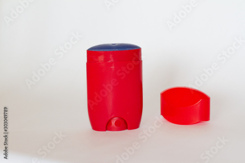 Body antiperspirant deodorant, open and closed empty red bottle with lid. antiperspirant on a white background. isolated. space for text. men's body care.
