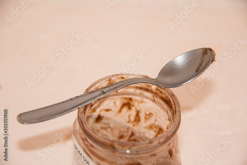 jar of honey and dipper on wooden background