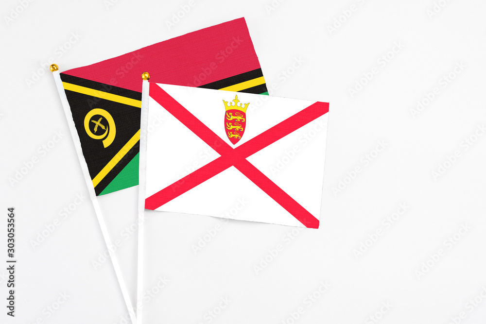 Jersey and Vanuatu stick flags on white background. High quality fabric, miniature national flag. Peaceful global concept.White floor for copy space. Jersey and Vanuatu stick flags on white background. High quality fabric, miniature national flag. Peaceful global concept.White floor for copy space.