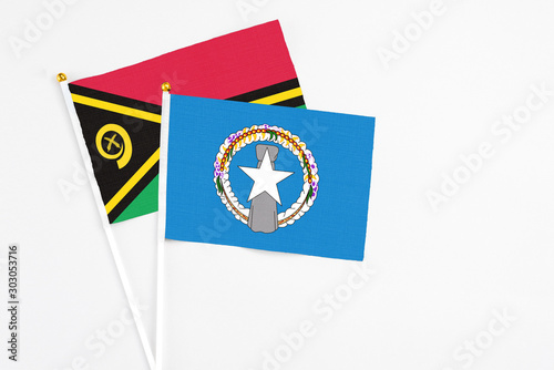 Free Download Northern Mariana Islands and Vanuatu stick flags on white background. High quality fabric, miniature national flag. Peaceful global concept.White floor for copy space. - GFXLoad
