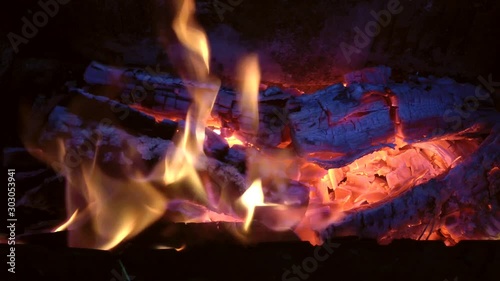 bright fire burns in a barbecue, burning wood to coals photo