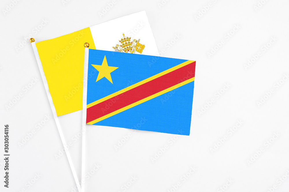 Congo and Vatican City stick flags on white background. High quality fabric, miniature national flag. Peaceful global concept.White floor for copy space. Congo and Vatican City stick flags on white background. High quality fabric, miniature national flag. Peaceful global concept.White floor for copy space.