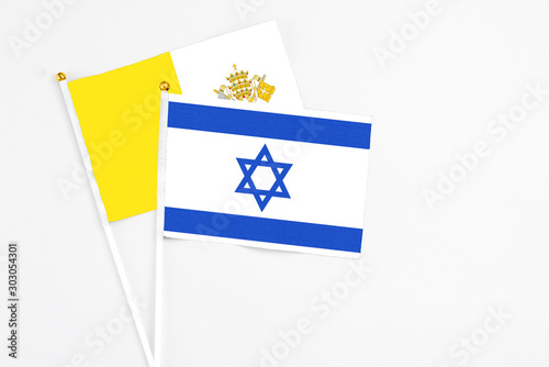 Free Download Israel and Vatican City stick flags on white background. High quality fabric, miniature national flag. Peaceful global concept.White floor for copy space. - GFXLoad