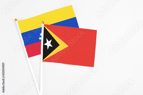 East Timor and Venezuela stick flags on white background. High quality fabric, miniature national flag. Peaceful global concept.White floor for copy space. Free Download East Timor and Venezuela stick flags on white background. High quality fabric, miniature national flag. Peaceful global concept.White floor for copy space. - GFXLoad
