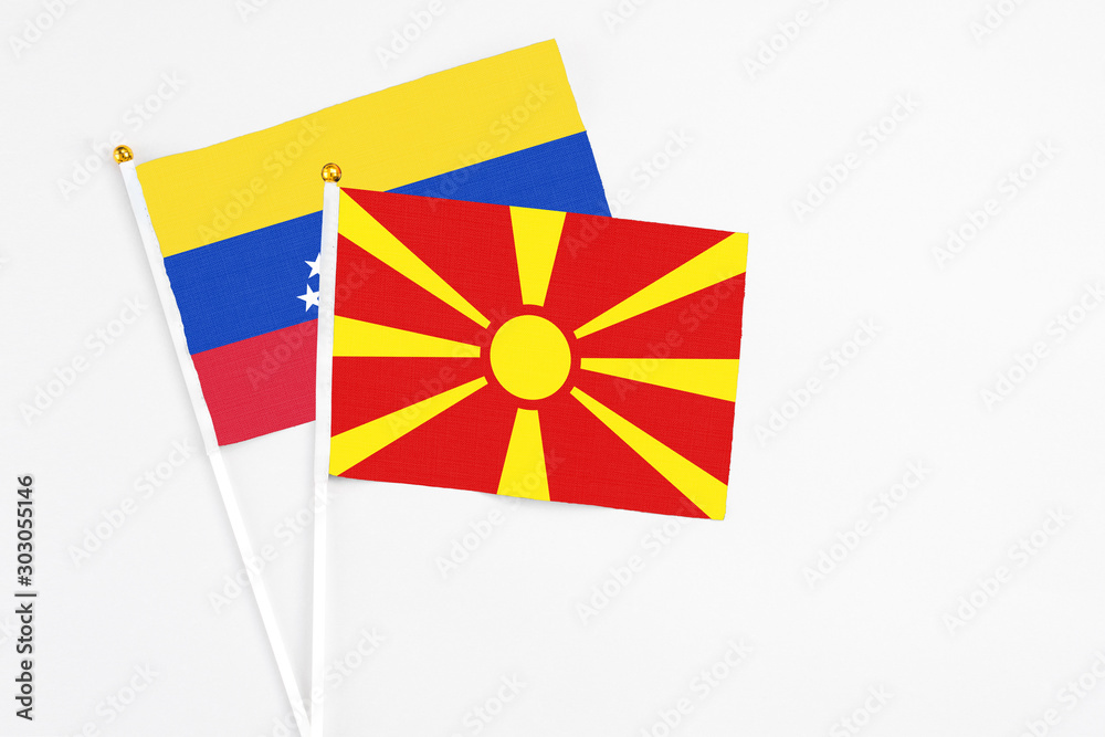 Macedonia and Venezuela stick flags on white background. High quality fabric, miniature national flag. Peaceful global concept.White floor for copy space.