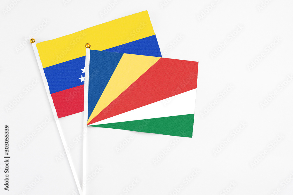 Seychelles and Venezuela stick flags on white background. High quality fabric, miniature national flag. Peaceful global concept.White floor for copy space. Seychelles and Venezuela stick flags on white background. High quality fabric, miniature national flag. Peaceful global concept.White floor for copy space.
