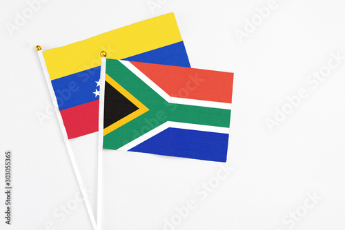 South Africa and Venezuela stick flags on white background. High quality fabric  miniature national flag. Peaceful global concept.White floor for copy space.
