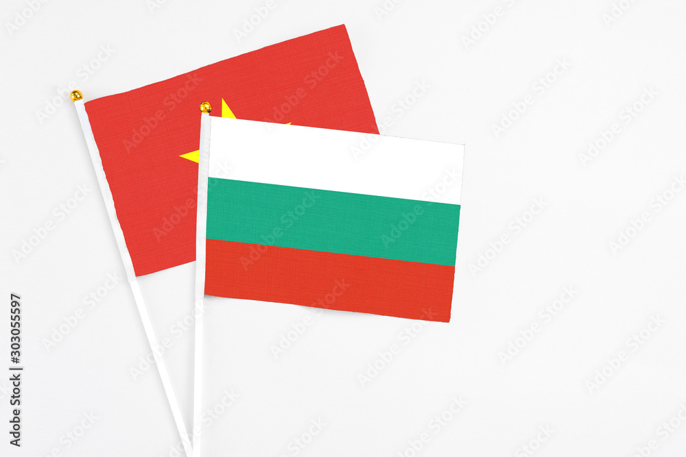 Bulgaria and Vietnam stick flags on white background. High quality fabric, miniature national flag. Peaceful global concept.White floor for copy space. Bulgaria and Vietnam stick flags on white background. High quality fabric, miniature national flag. Peaceful global concept.White floor for copy space.