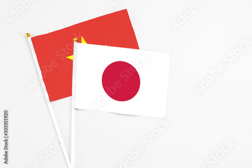 Japan and Vietnam stick flags on white background. High quality fabric, miniature national flag. Peaceful global concept.White floor for copy space. Free Download Japan and Vietnam stick flags on white background. High quality fabric, miniature national flag. Peaceful global concept.White floor for copy space. - GFXLoad