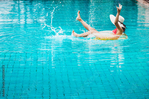 Bikini woman relaxation on pool float
